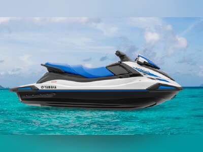 650b35f3ae63ea6ac8763123 a blue and white boat sitting next to a body of water