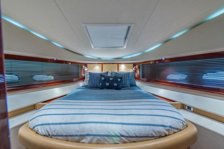 a bedroom with a bed and a chair in a room