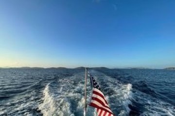 a person standing next to a body of water